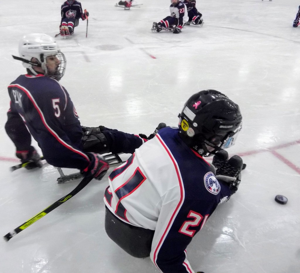 Blue Jackets players skating by eachother